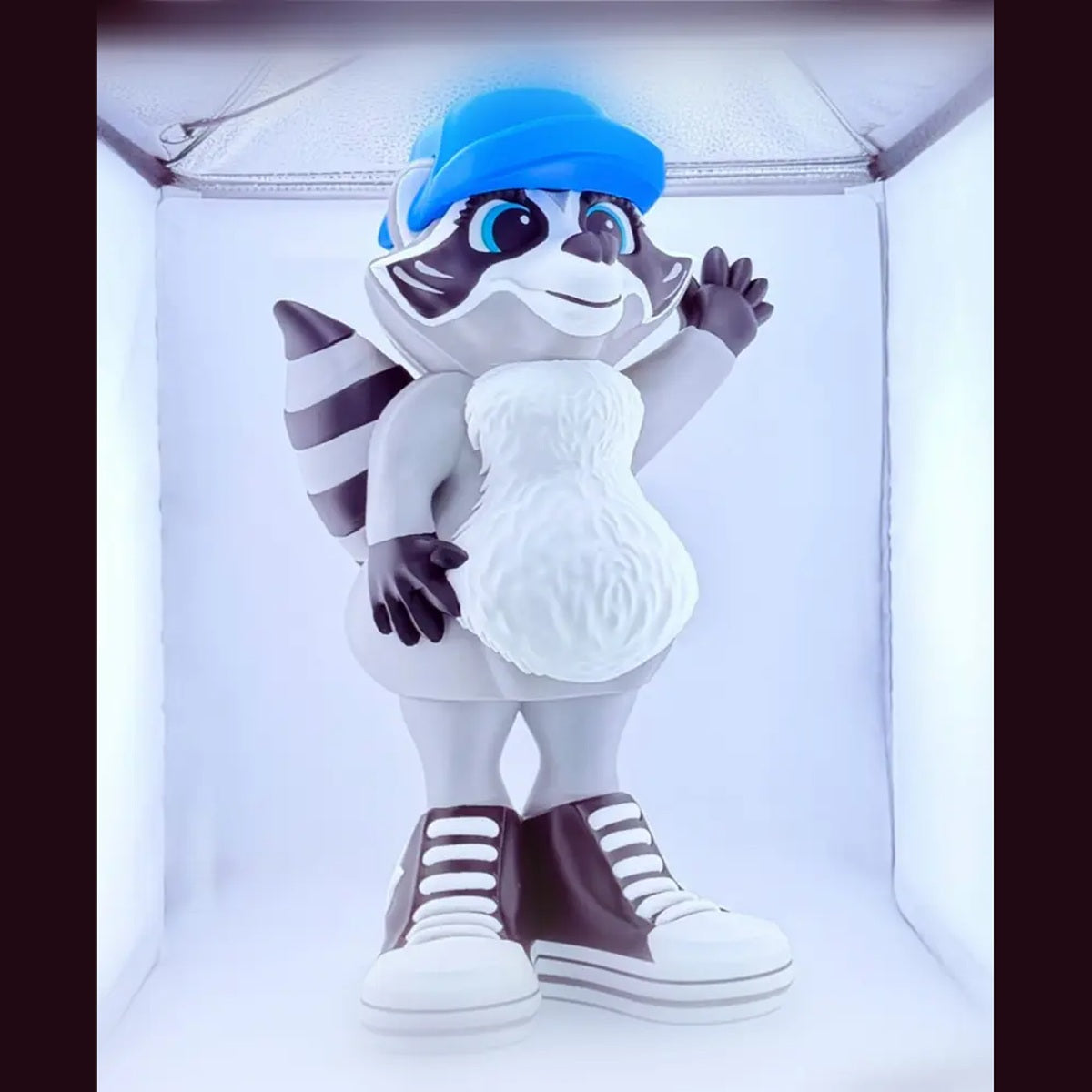 Dress-Up Raccoon shown with blue hat and sneakers