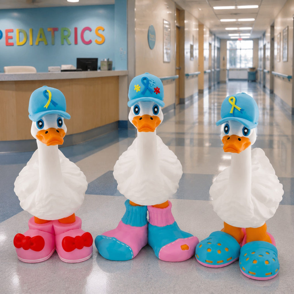 Prints & Giggles 3D awareness ribbon hats on three white goose figurines in a pediatric hospital hallway