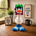 Prints & Giggles 3D Father's Day goose outfit featuring a DAD #1 frame hat, navy baseball cap, and blue sock shoes.