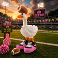 Prints & Giggles 3D goose figurine wearing a football hat and pink sneakers on a football field at sunset