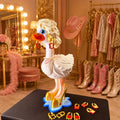 Dolly Dress-Up Goose outfit with blonde hair gold heels and earrings