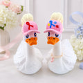 Dress-Up Goose wearing awareness ribbon and puzzle-piece hats